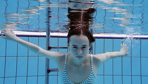 Slim redhead sweetie Anna Netrebko swims naked under water