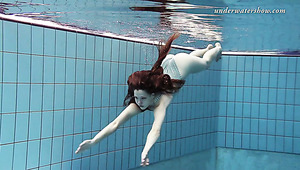 Slim girl Salaka Ribkina swimming in the pool all naked