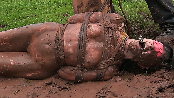 Ample dark haired whore rolls in mud under guidance of horny master