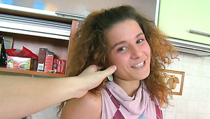Playful redhead teen with curly hair eats sugary cock at the kitchen
