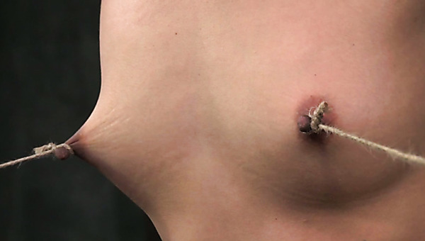 Ruined brunette doxy gets her nipples tied to her feet under pressure