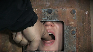 Shy caged bitch looks at her red haired hot pal Ashley Lane getting tied in upside down pose